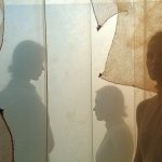 Interwoven layers of mesh and burlap with shifting light and shadow, evoking the mix of textures and temperatures travelers face in transit.